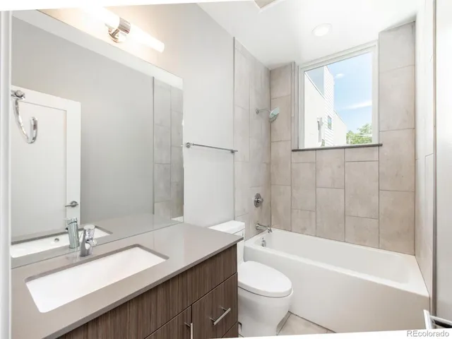 a view of an empty room with wooden floor and closet
