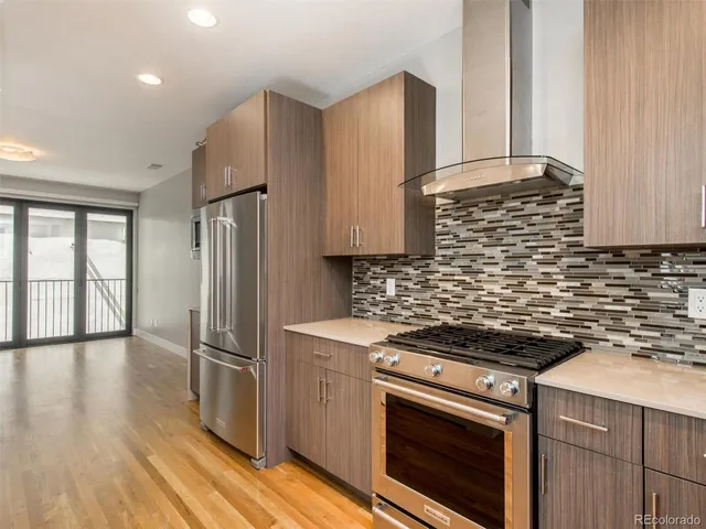 a kitchen with stainless steel appliances a stove a refrigerator and cabinets
