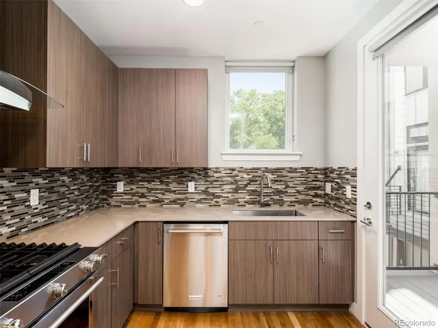 a kitchen with granite countertop wooden cabinets and a stove top oven