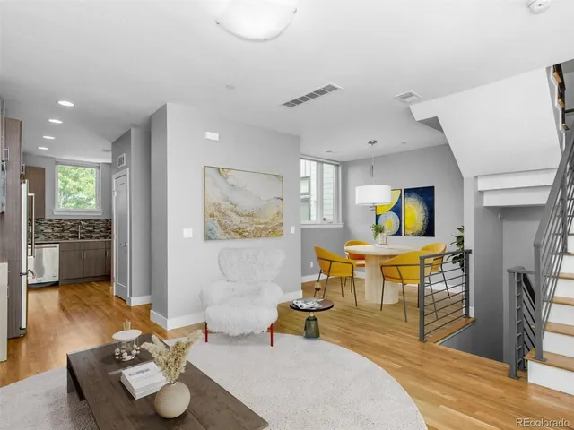 a living room with furniture and stairs