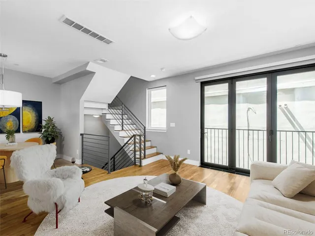 a balcony with furniture and a potted plant