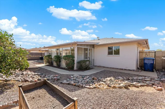 a view of a patio with table and chairs and potted plants