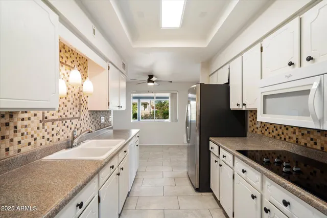 a kitchen with refrigerator and cabinets