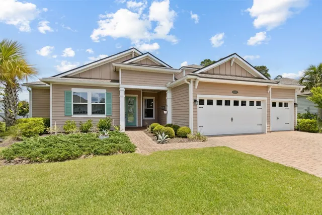 a front view of a house with yard and porch