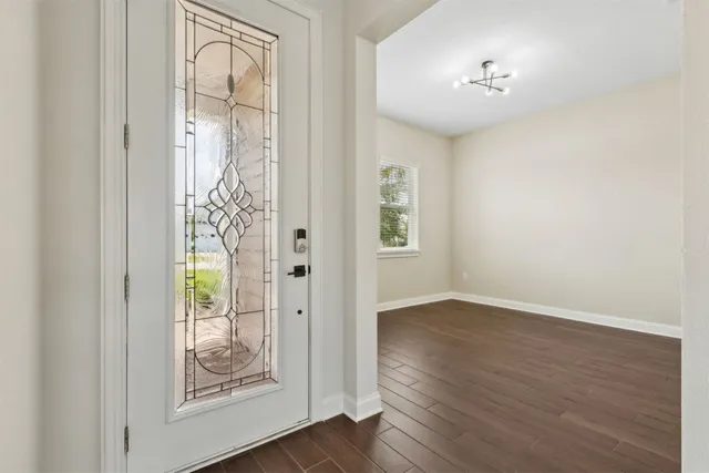 a view of an empty room with wooden floor