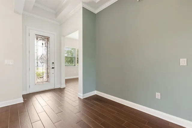 a living room with furniture and a view of kitchen