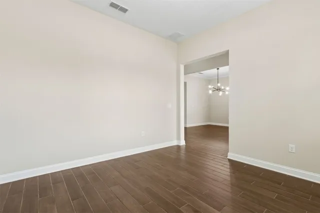 a view of kitchen with stainless steel appliances granite countertop a stove top oven a refrigerator and a sink