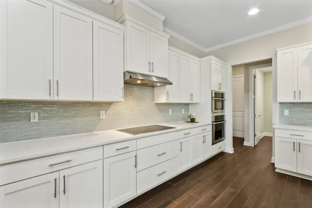 a dining room with furniture a chandelier and wooden floor