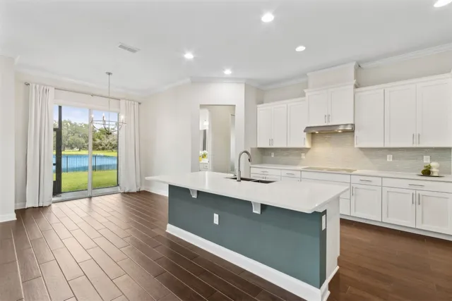 a bedroom with a bed and a large window with the outer view