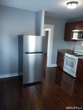 a kitchen with a refrigerator and a stove top oven