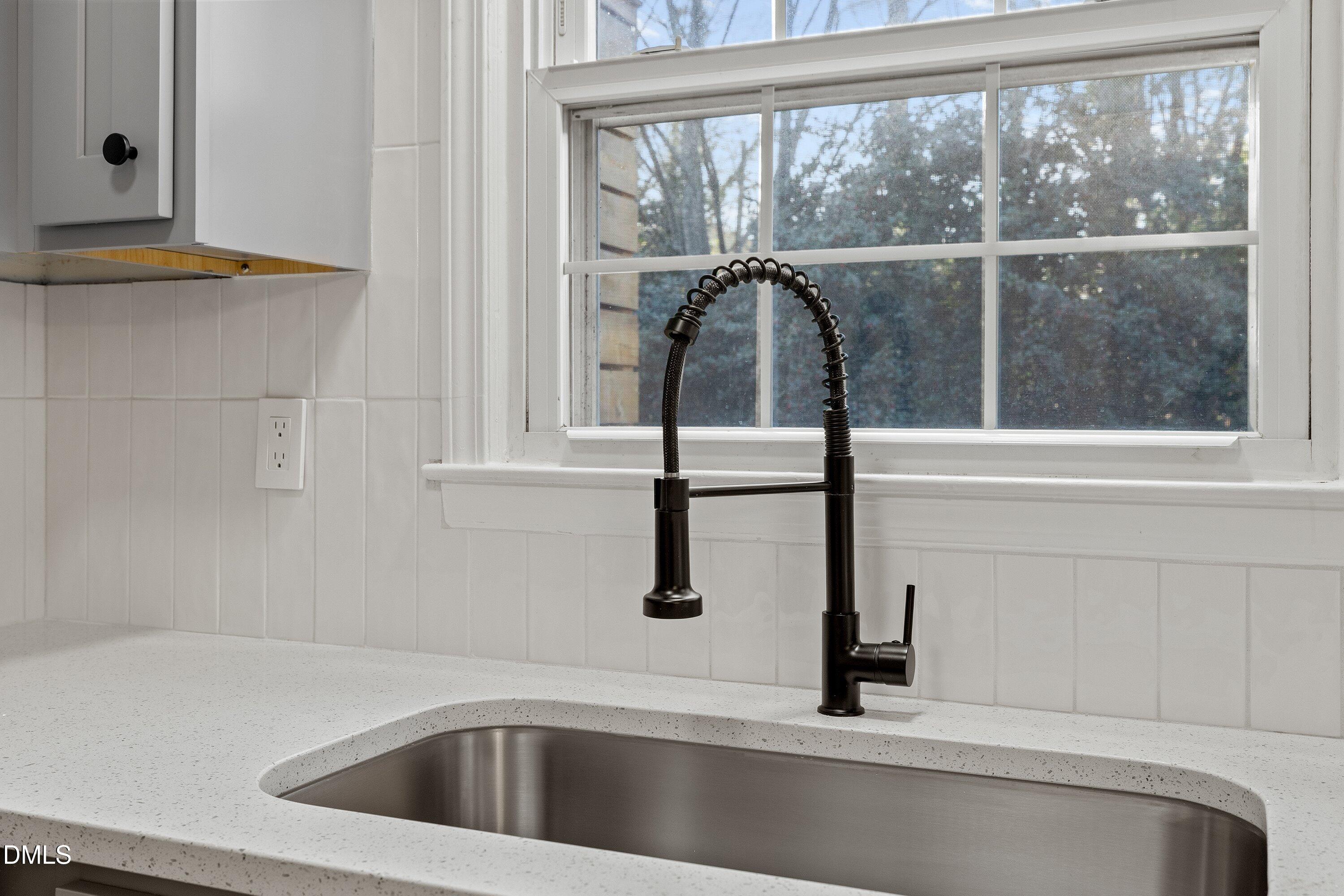 4705 Blue Bird Court, Unit E Raleigh, NC 27606 - Photo 11 of 32 a kitchen with a sink and bathtub