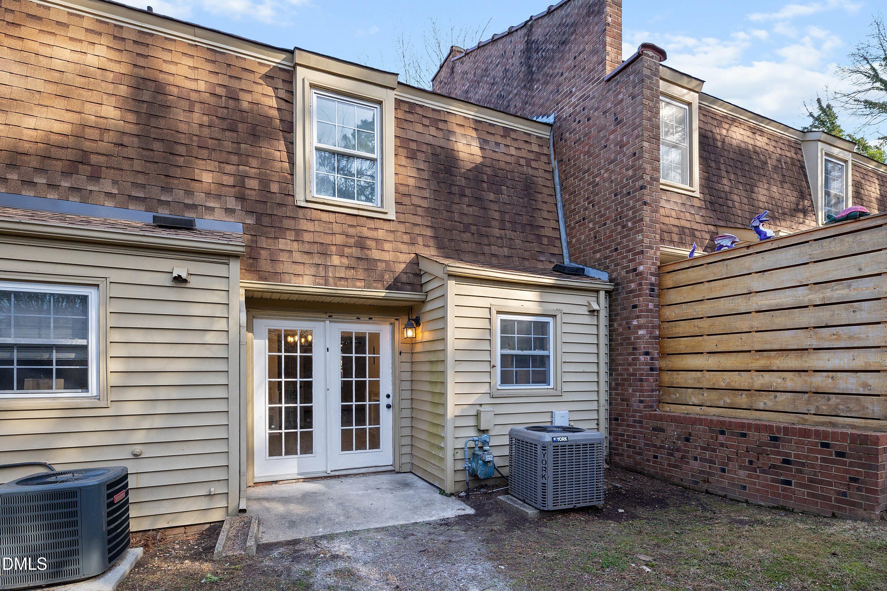 4705 Blue Bird Court, Unit E Raleigh, NC 27606 - Photo 29 of 32 a view of a house with a door and wooden floor