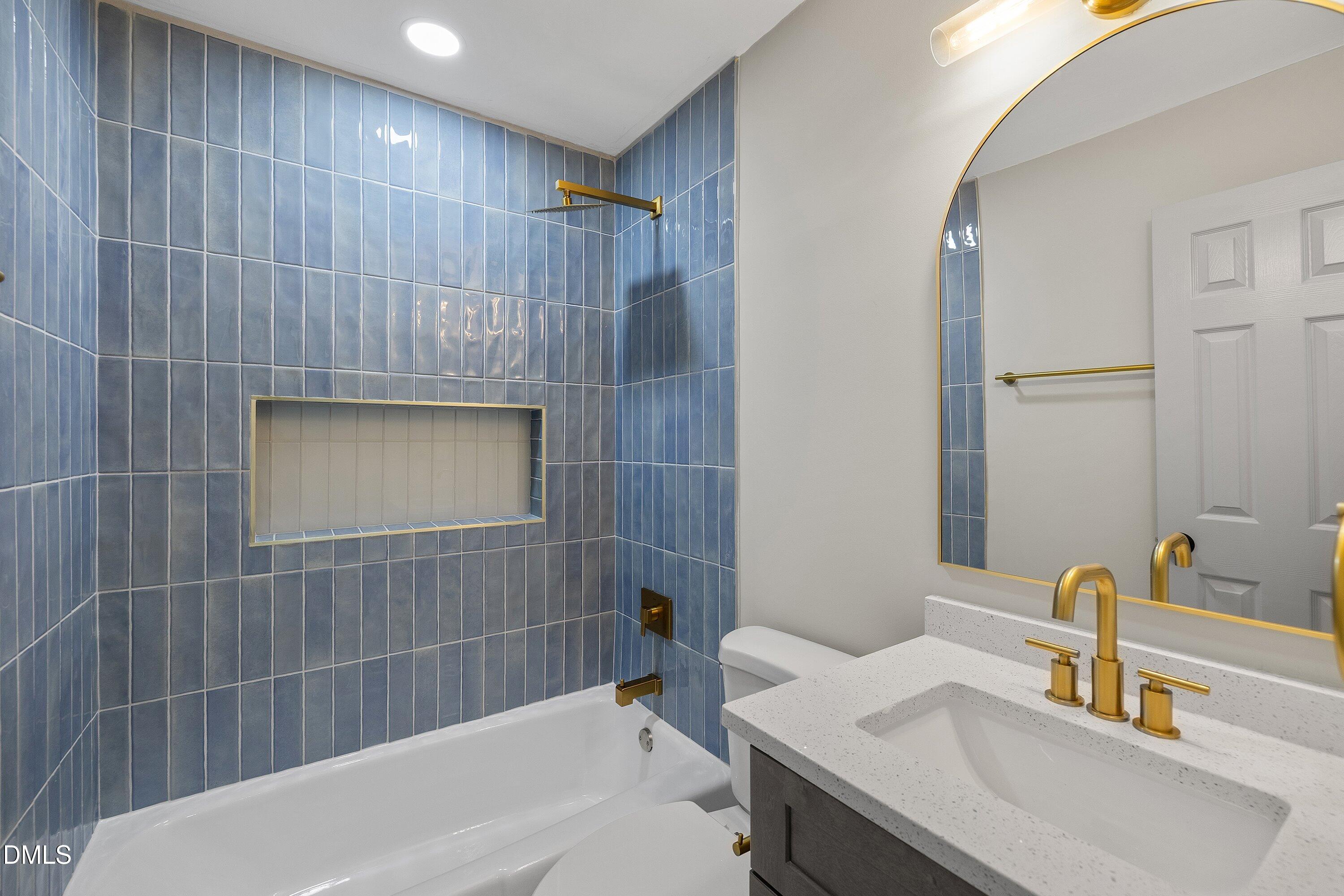 4705 Blue Bird Court, Unit E Raleigh, NC 27606 - Photo 3 of 32 a bathroom with a sink and a mirror