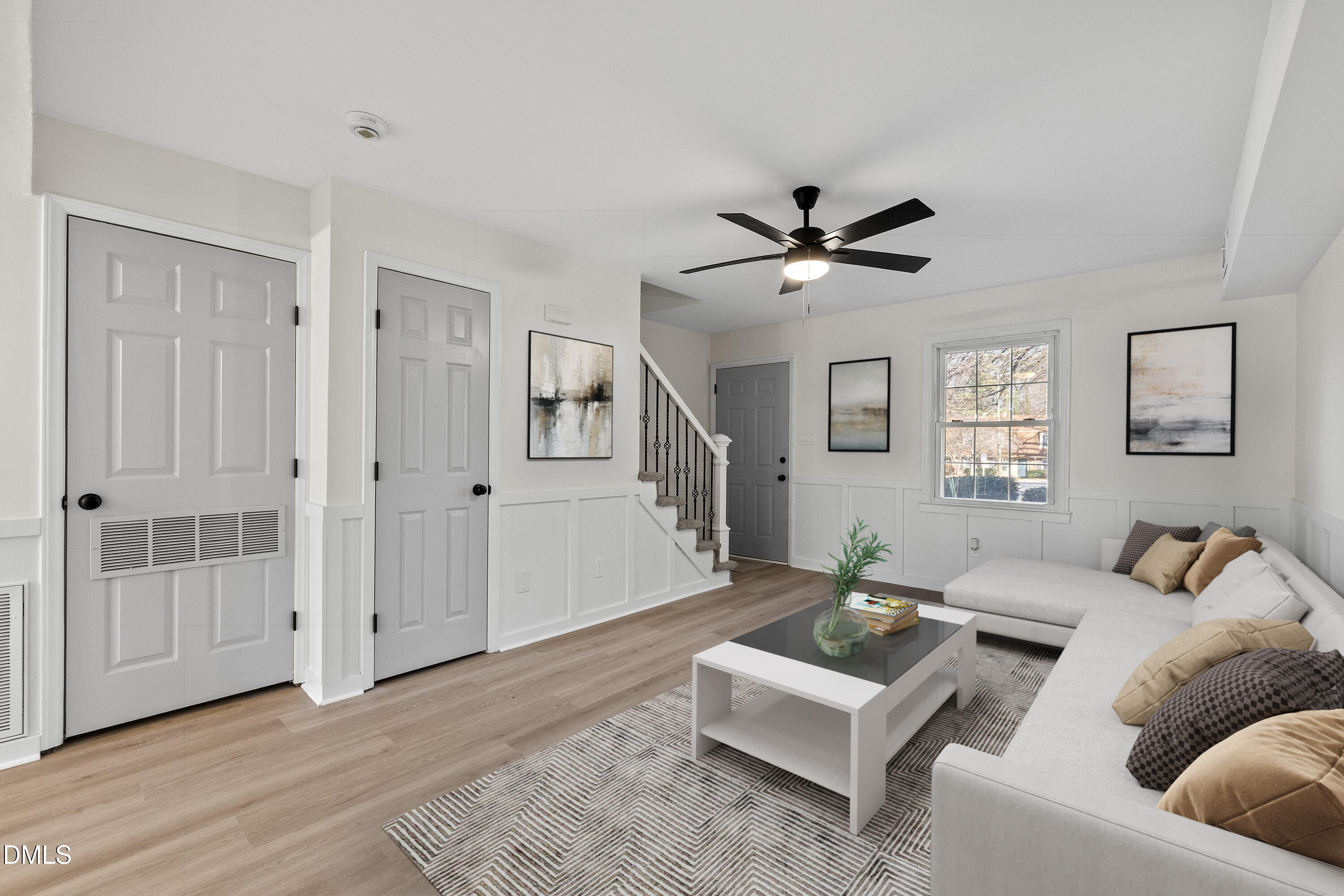 4705 Blue Bird Court, Unit E Raleigh, NC 27606 - Photo 4 of 32 a living room with furniture and a ceiling fan
