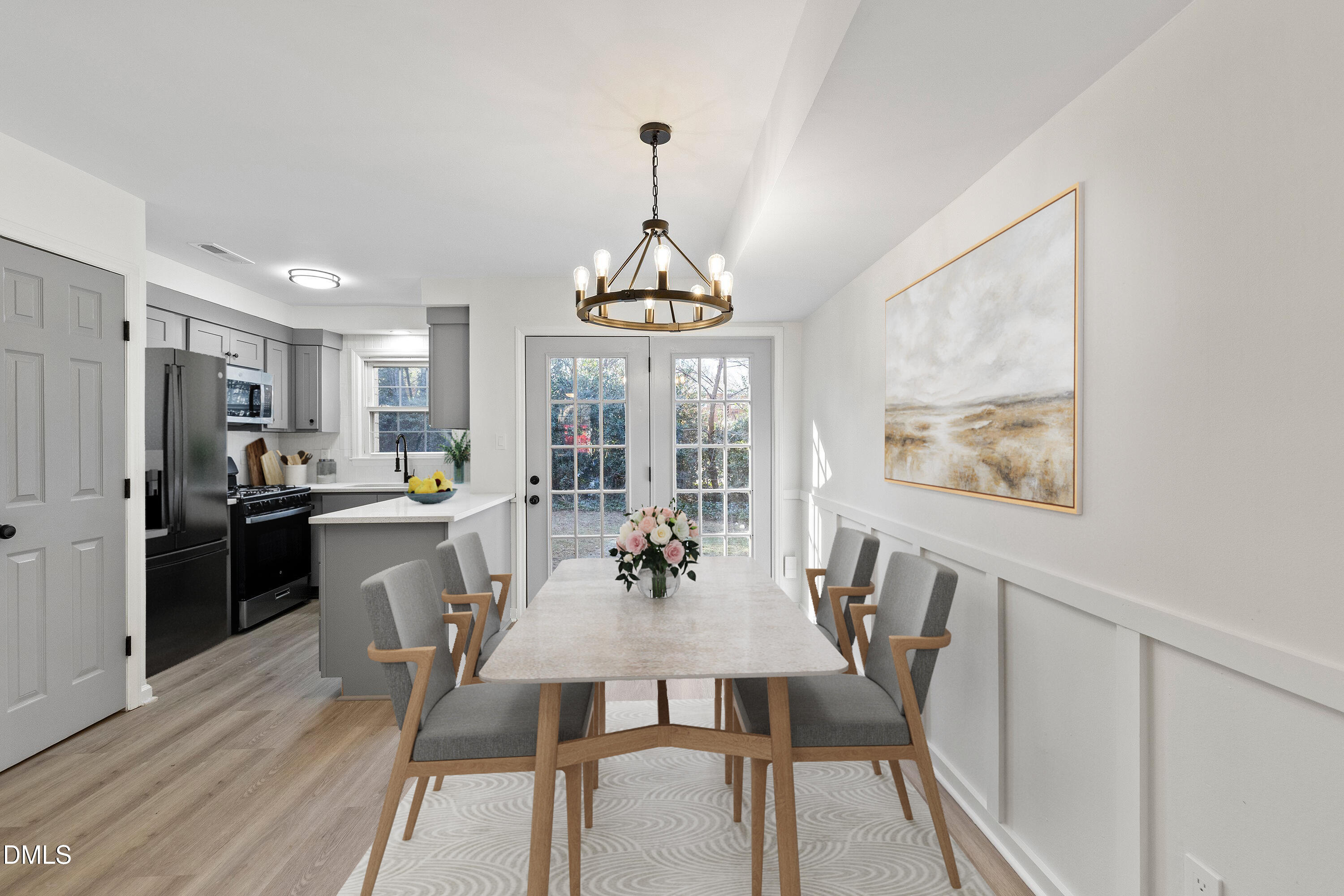 4705 Blue Bird Court, Unit E Raleigh, NC 27606 - Photo 6 of 32 a view of a dining room with furniture window and wooden floor
