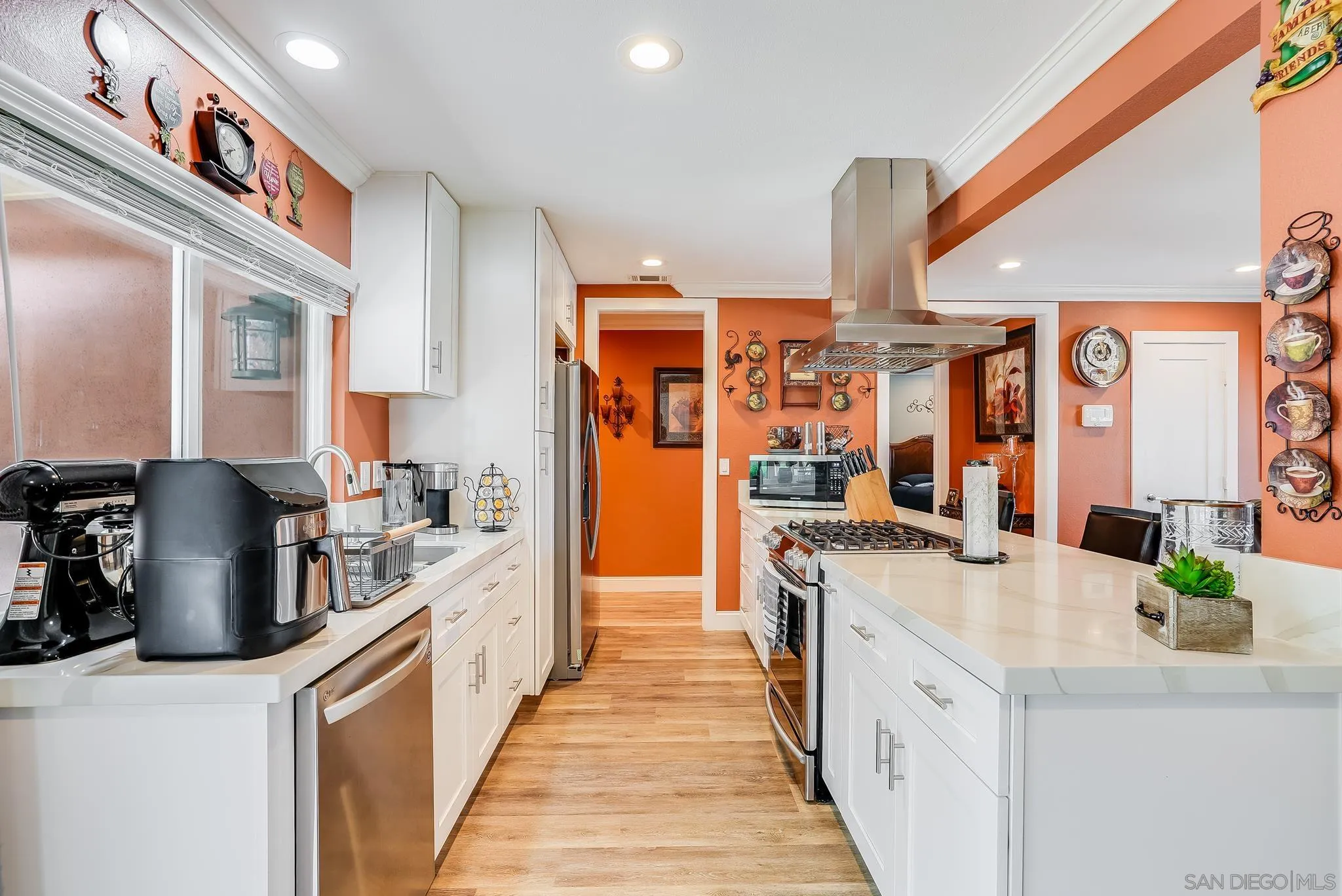 1851 Ithaca Street Chula Vista, CA 91913 - Photo 12 of 34 a kitchen with stainless steel appliances granite countertop a sink and a refrigerator