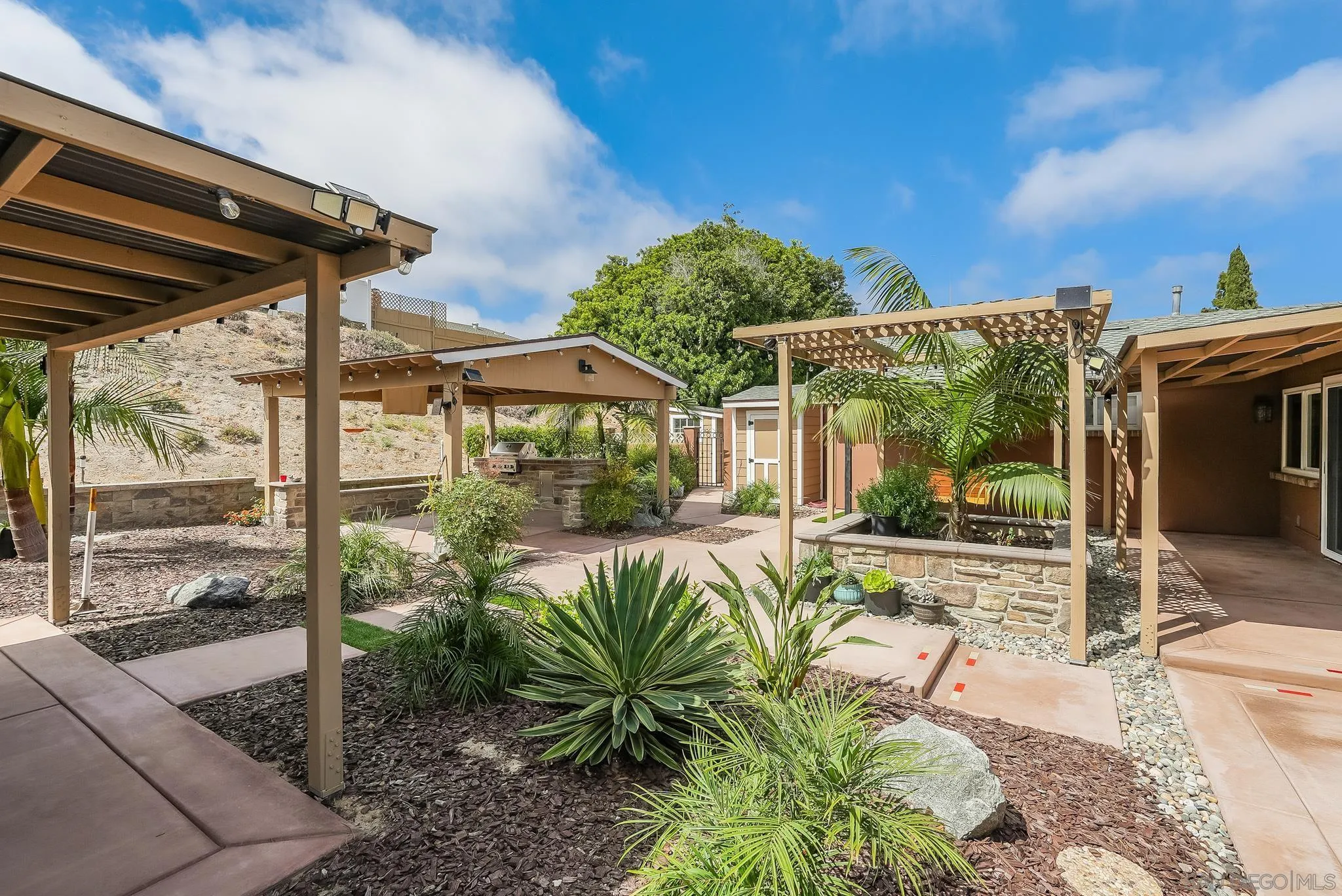 1851 Ithaca Street Chula Vista, CA 91913 - Photo 3 of 34 a view of a patio with table and chairs potted plants with wooden floor and floor to ceiling window