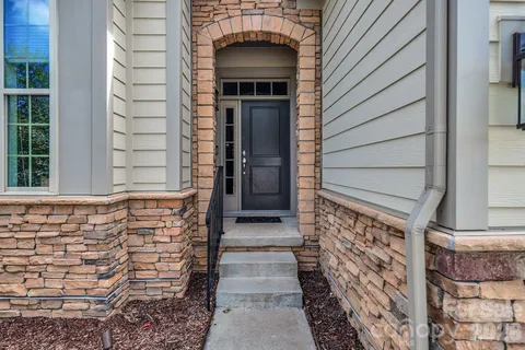 a view of front door of house with stairs