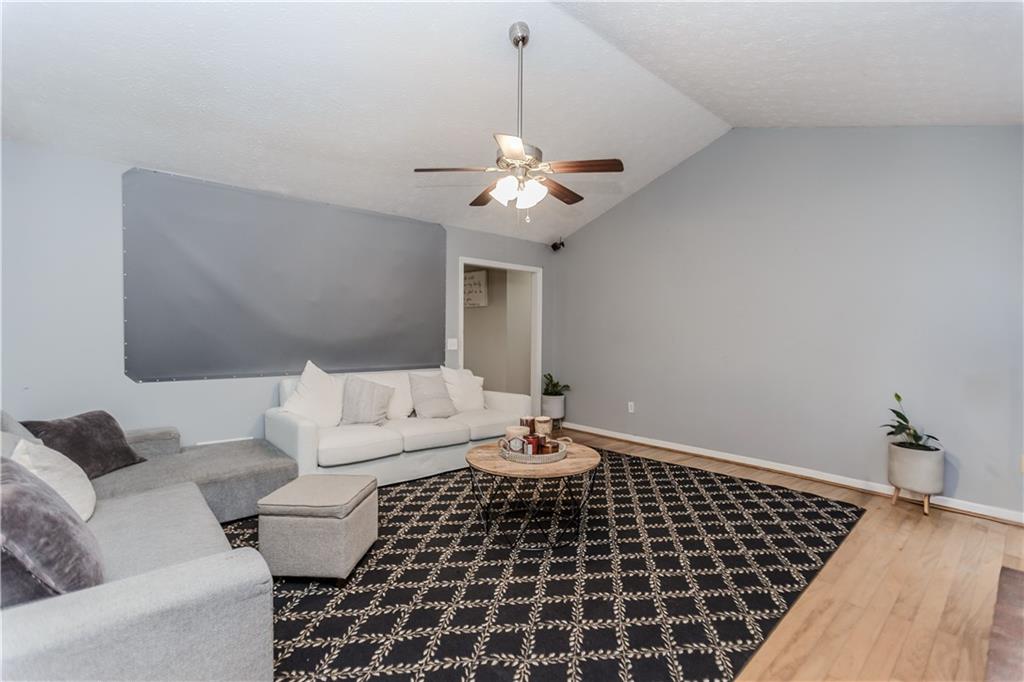2790 Alcovy River View Dacula, GA 30019 - Photo 12 of 25 a living room with furniture and a chandelier