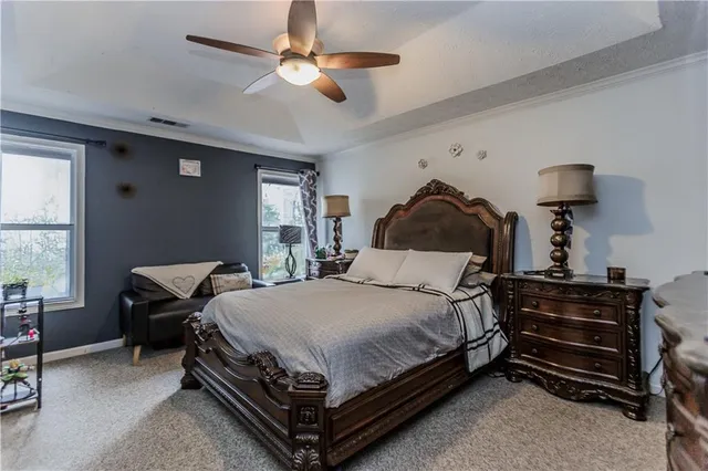 a bedroom with a bed dresser and a window