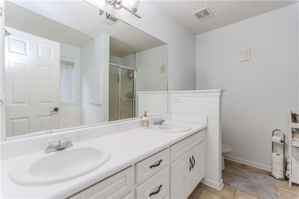 2790 Alcovy River View Dacula, GA 30019 - Photo 16 of 25 a bathroom with a sink and a mirror