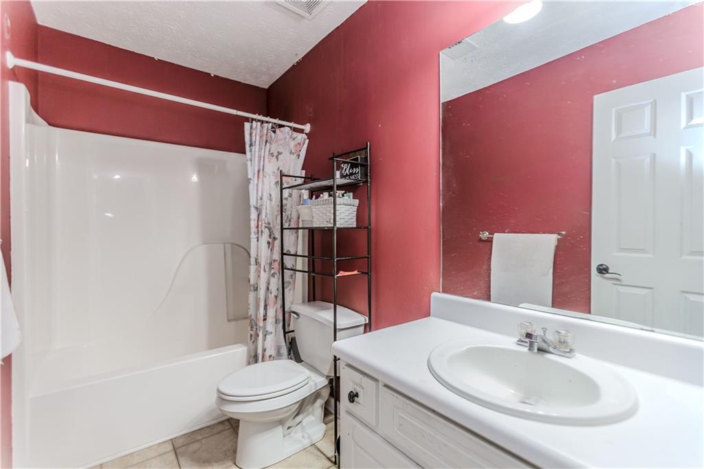2790 Alcovy River View Dacula, GA 30019 - Photo 18 of 25 a bathroom with a sink toilet and shower