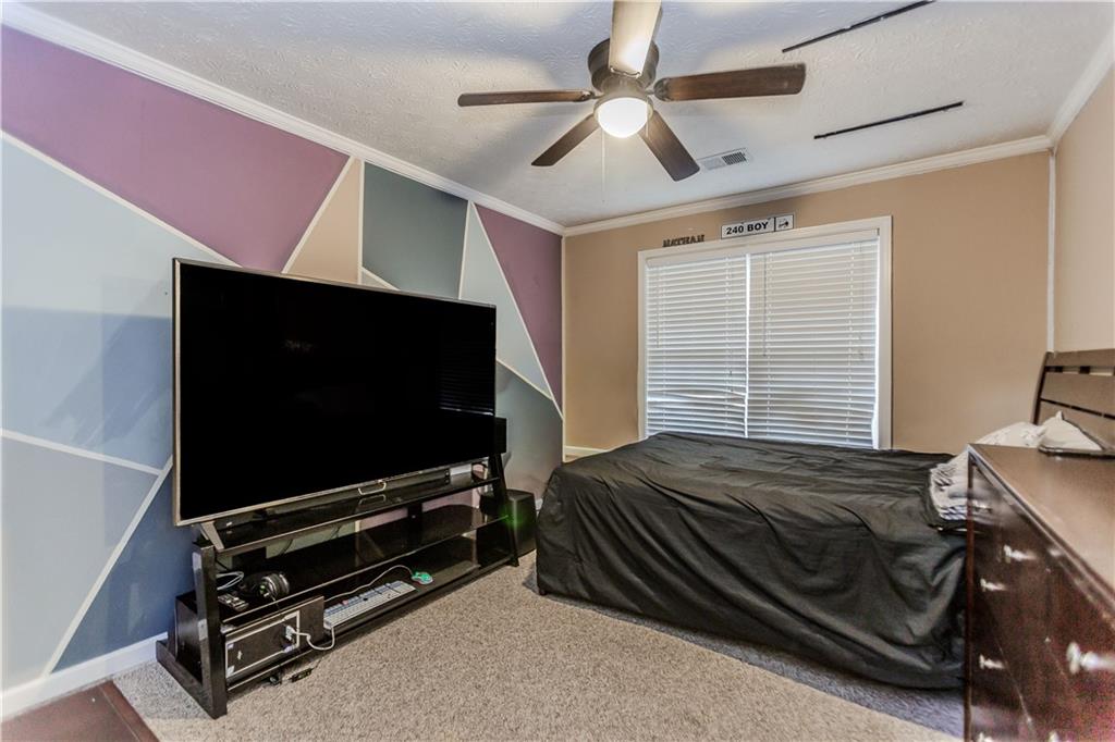 2790 Alcovy River View Dacula, GA 30019 - Photo 21 of 25 a bedroom with a bed and flat screen tv