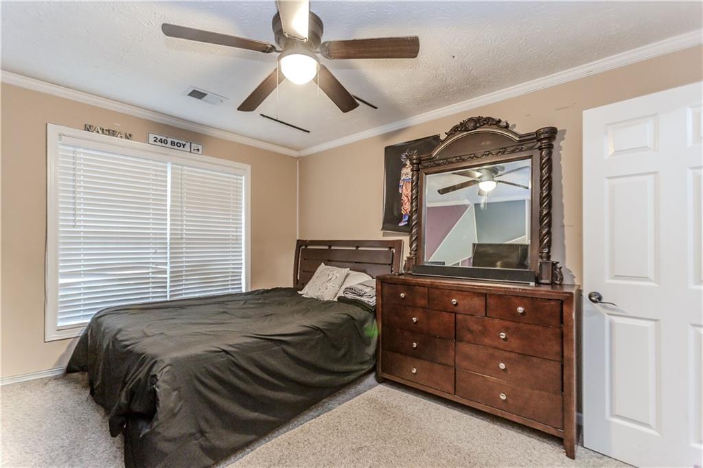 2790 Alcovy River View Dacula, GA 30019 - Photo 22 of 25 a bedroom with a bed and a dresser