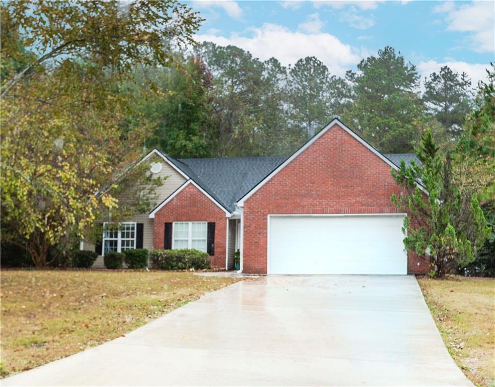 2790 Alcovy River View Dacula, GA 30019 - Photo 3 of 25 a front view of a house with a yard and garage