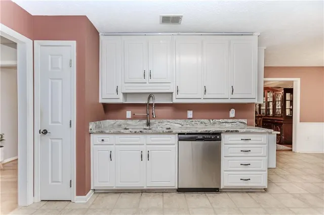 a kitchen with stainless steel appliances granite countertop a sink and cabinets