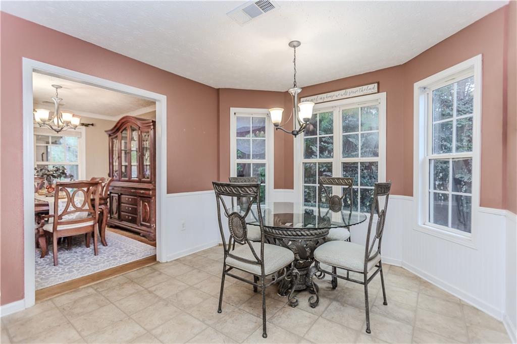 2790 Alcovy River View Dacula, GA 30019 - Photo 7 of 25 a view of a dining room with furniture large windows and wooden floor