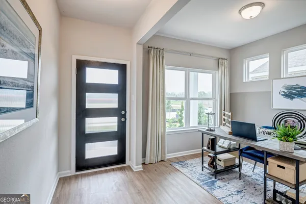 a workspace with wooden floor and a window