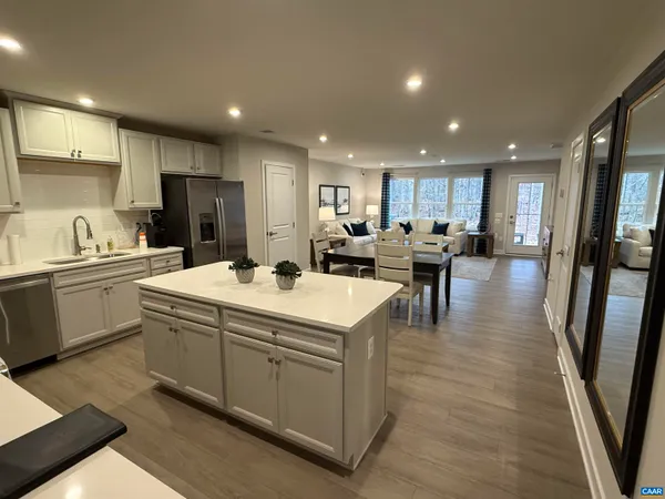 a kitchen with a sink stainless steel appliances and cabinets