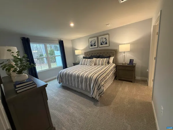a bedroom with a bed and a couch