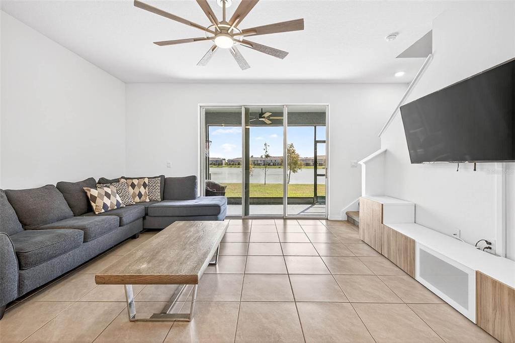 193 Mangrove Shade Circle Apollo Beach, FL 33572 - Photo 15 of 47 a living room with a flat screen tv and a floor to ceiling window