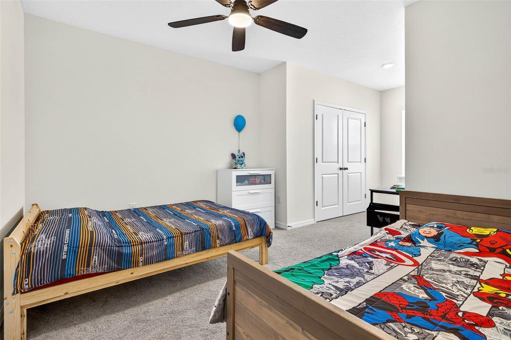 193 Mangrove Shade Circle Apollo Beach, FL 33572 - Photo 20 of 47 a bedroom with a bed and a table in it