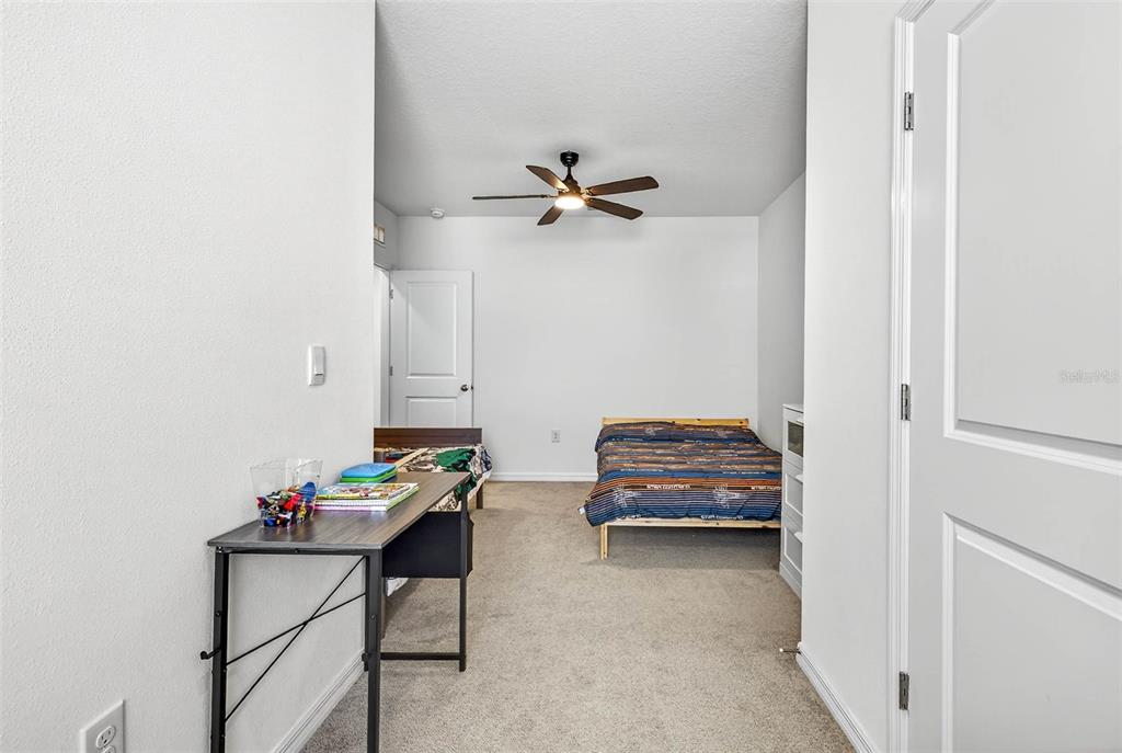 193 Mangrove Shade Circle Apollo Beach, FL 33572 - Photo 22 of 47 a bedroom with furniture and a chandelier fan