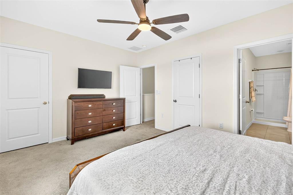 193 Mangrove Shade Circle Apollo Beach, FL 33572 - Photo 29 of 47 a bedroom with a bed and a flat screen tv