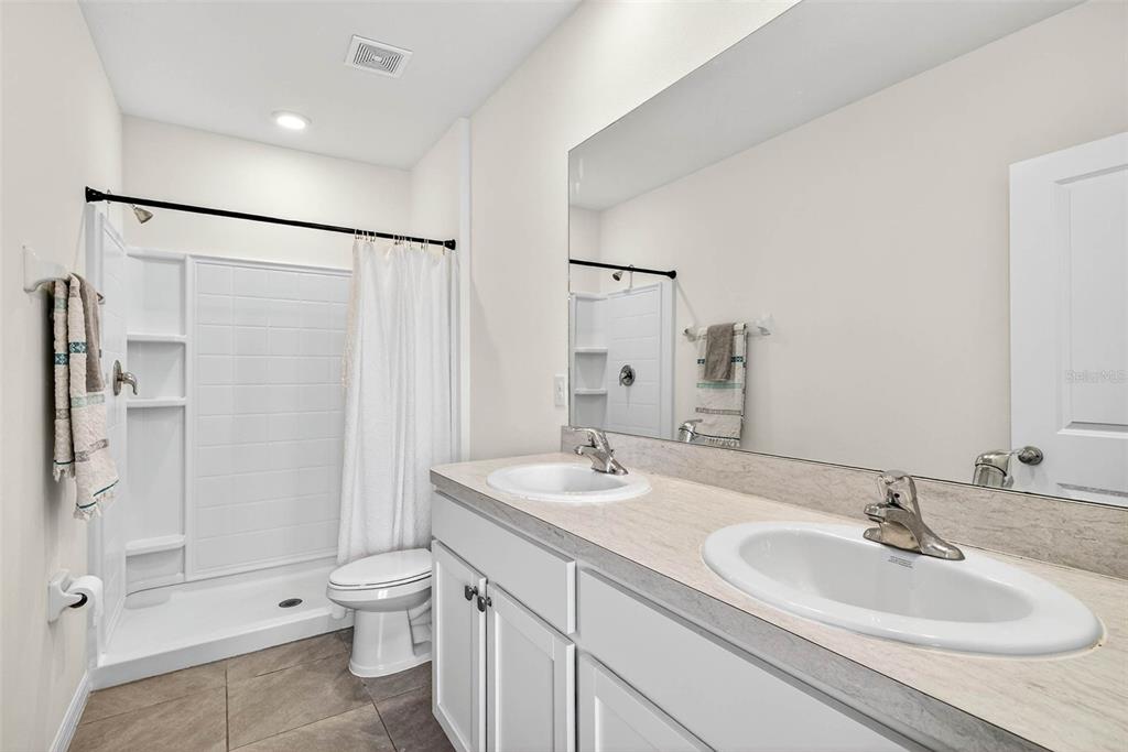193 Mangrove Shade Circle Apollo Beach, FL 33572 - Photo 30 of 47 a bathroom with a sink toilet double vanity and shower