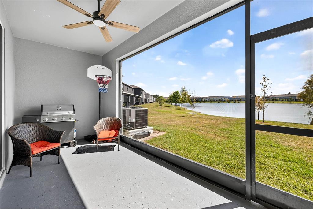 193 Mangrove Shade Circle Apollo Beach, FL 33572 - Photo 32 of 47 a living room with dining table and a large window