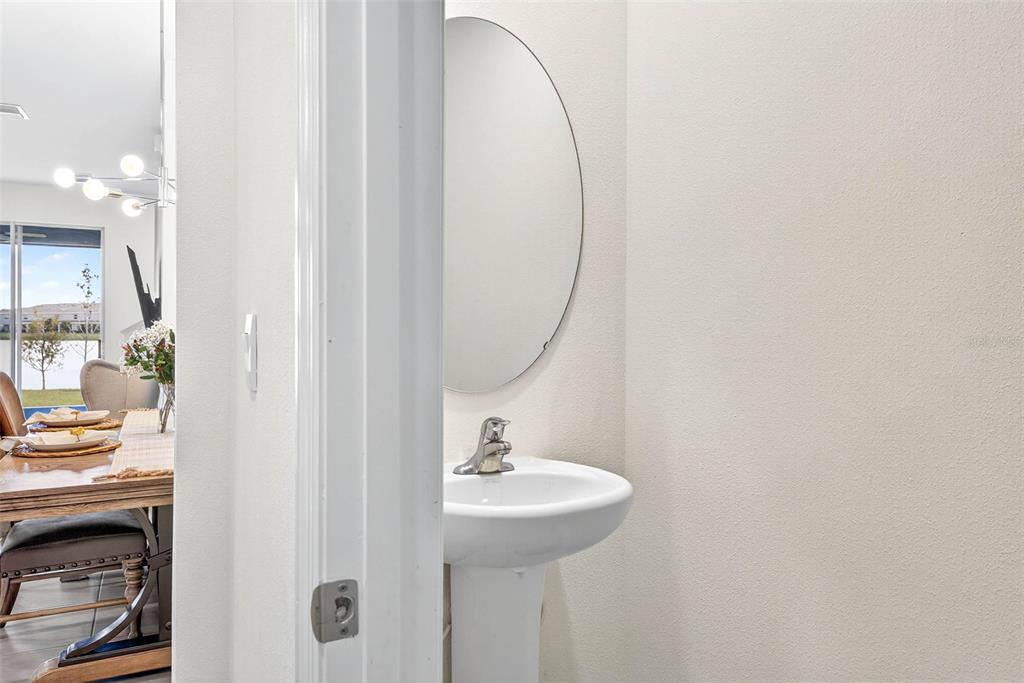 193 Mangrove Shade Circle Apollo Beach, FL 33572 - Photo 8 of 47 a bathroom with a sink a light fixture and a mirror