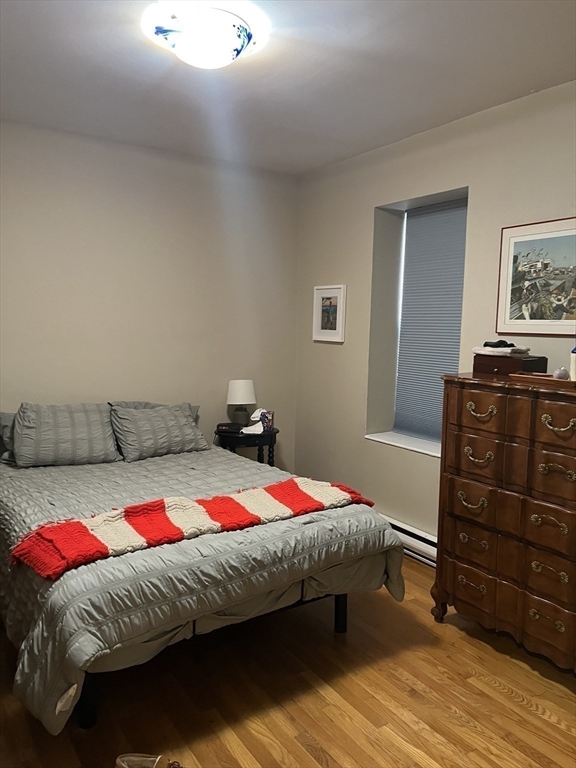 14 Linwood Street, Unit 2 Boston, MA 02119 - Photo 11 of 23 a bedroom with a bed and wooden floor