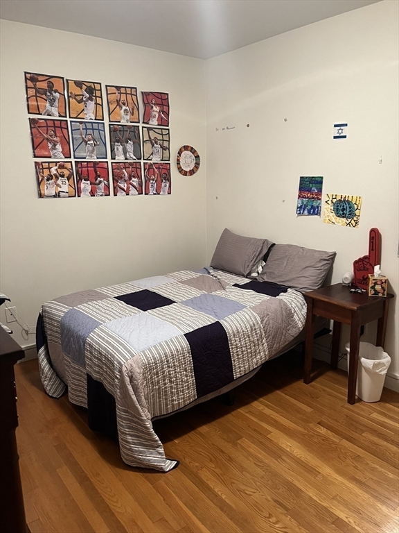 14 Linwood Street, Unit 2 Boston, MA 02119 - Photo 12 of 23 a bedroom with a bed and wooden floor