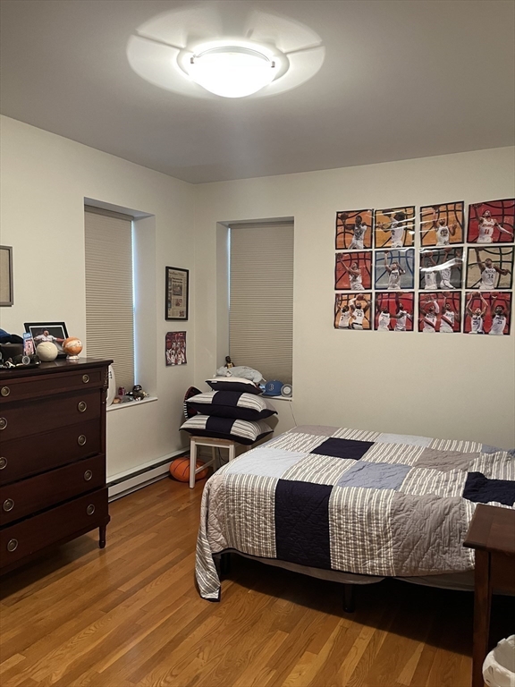 14 Linwood Street, Unit 2 Boston, MA 02119 - Photo 13 of 23 a bedroom with a bed and wooden floor