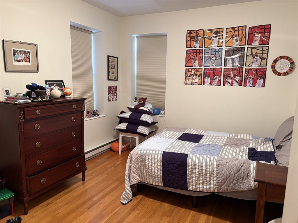 14 Linwood Street, Unit 2 Boston, MA 02119 - Photo 14 of 23 a bedroom with a bed and wooden floor