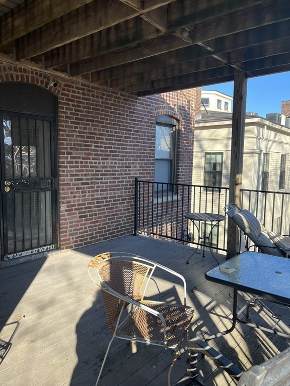 14 Linwood Street, Unit 2 Boston, MA 02119 - Photo 18 of 23 a view of a balcony with table and chairs