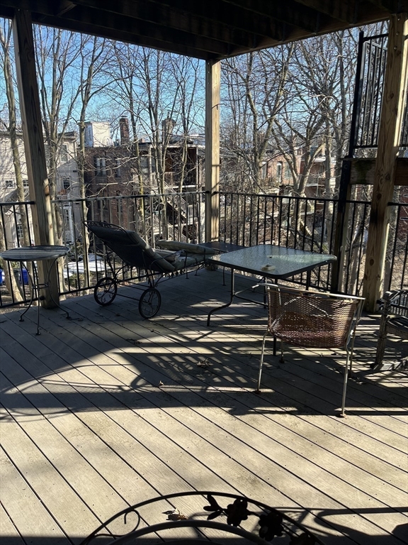 14 Linwood Street, Unit 2 Boston, MA 02119 - Photo 19 of 23 a view of a chairs and table on the wooden roof