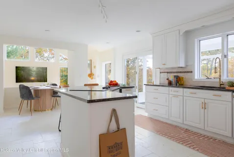 a kitchen with stainless steel appliances kitchen island granite countertop a sink and cabinets