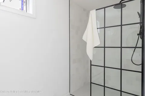a bathroom with a glass shower door