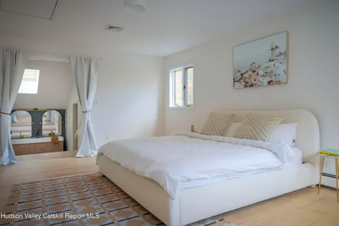 a bedroom with a large bed and a chandelier